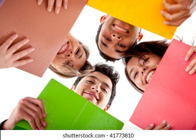 Group of students with notebooks and heads together isolated