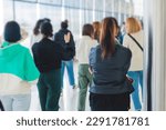 Group of students on excursion visit gallery museum with tour guide, a docent with a tourist adult visitors on an archaeology exhibition with contemporary art, paintings and exhibits
