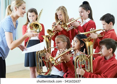 Group Of Students Playing In School Orchestra Together
