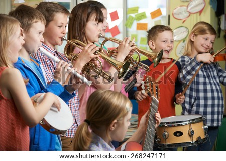 Group Of Students Playing In School Orchestra Together