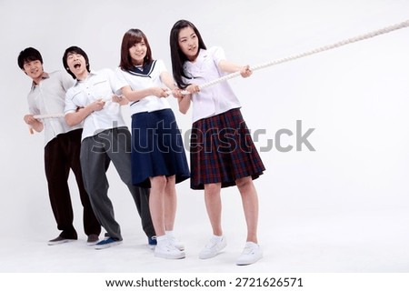 Group of students pulling a rope in a studio during a team activity in Japan on a clear day