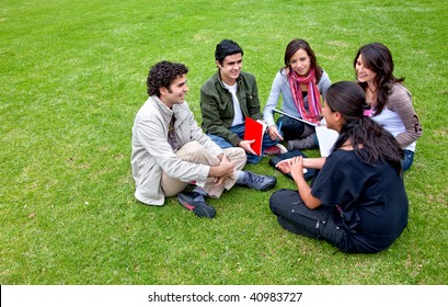 Group Of Students Sitting In A Circle Outdoors