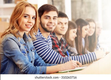 Group of students sitting in classroom - Shutterstock ID 310263716