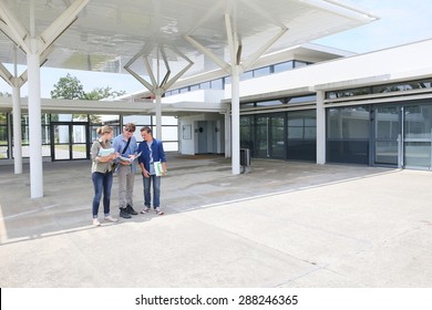 Group Of Students Standing By School Building