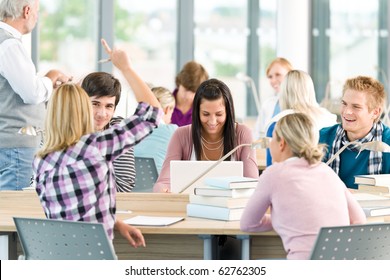 Group Of Students Study In Classroom At High School With Professor