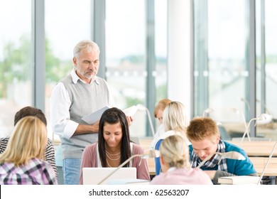 Group Of Students Study In Classroom At Highschool With Professor