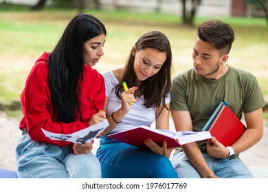 Group Of Students Studying Outdoor In Park Near School, College Or University