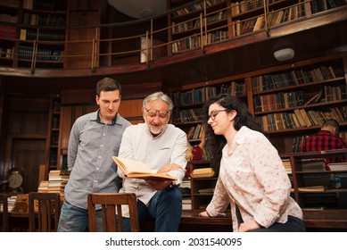 Group of students studying together at the University library - Powered by Shutterstock