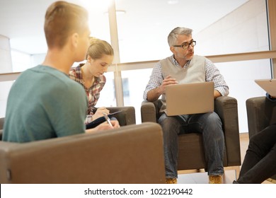 Group Of Students With Teacher In Lounge Room