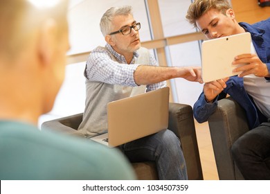 Group Of Students With Teacher In Lounge Room