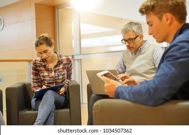 Group Of Students With Teacher In Lounge Room