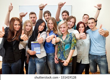 Group of students at the university with thumbs up