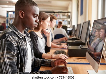 Group Of Students Using Computers In College Library