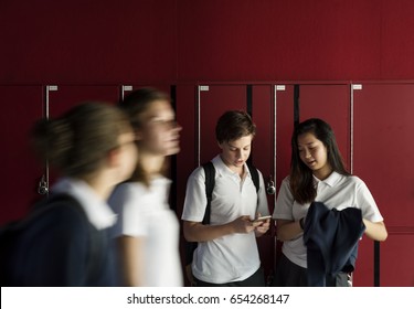 Group of students using mobile phone on hallway - Powered by Shutterstock