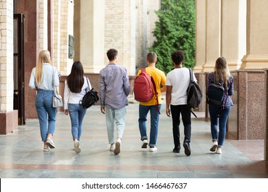 Group Of Students Walking In College Campus After Classes, Back View