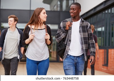 Group Of Students Walking Outside College Buildings