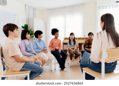Group study session with diverse students seated in a circle engaging in a classroom discussion led by a teacher, emphasizing interactive learning and participation in a primary education environment
