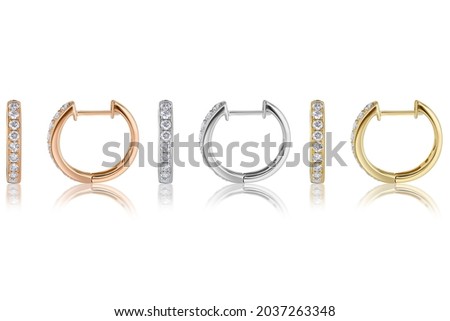 Group Subject Shot of Diamond Huggie Hoop Earrings on a White Background with Reflection. Earrings metal is 14k Rose White and Yellow Gold. 