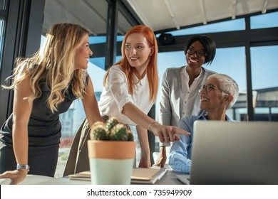 A Group Of Succesful Women Working On A Project In A Beautiful Sunny Office.