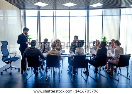 a group of successful afro americans, europeans ,arabic and korean businessman and businesswoman working in the office with large glass windows