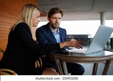 Group Of Successful Business People Having Meeting Together, Two Colleagues Working Together Outside The Office, Young Man And Woman Sitting With Laptop Computer And Have A Discussion, Success Concept