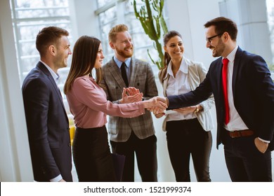 Group of successful business people standing in the office - Shutterstock ID 1521999374