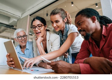 Group of successful happy multiethnic business people working as a team in office on meeting. - Powered by Shutterstock