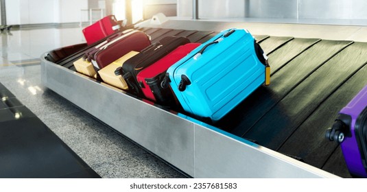 Group of suitcases on conveyor belt in airport - Shutterstock ID 2357681583