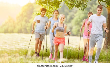 Group In Summer Nordic Walking In Their Fitness Class