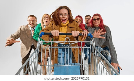 Group of super emotional and excited people pushing shopping cart forward with craziness. Competition for best deals. Concept of Black Friday, Cyber Monday, shopping