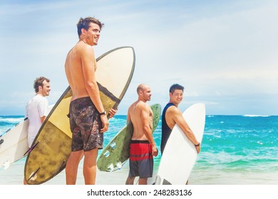 Group Of Surfers On A Beach