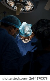 Group of surgeons and nurses collaborating during a surgical procedure in a hospital operating room.