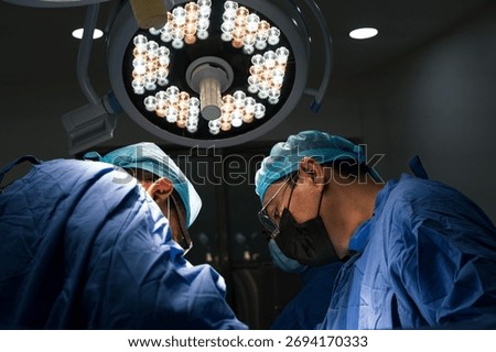 Group of surgeons and nurses collaborating during a surgical procedure in a hospital operating room.