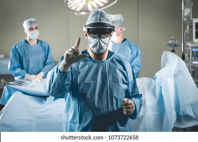 Group of surgeons using augmented reality holographic hololens glasses while operating in modern operation theater