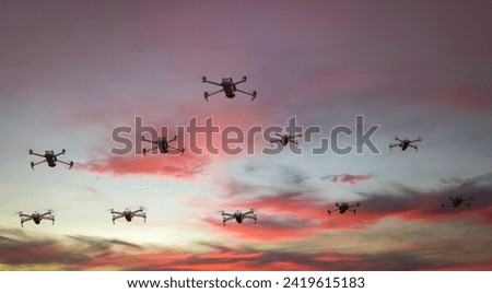 Group of surveillance drones in front  with sunset sky scene background