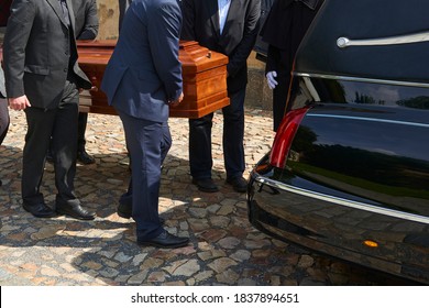 Group Of Survivors Puts A Coffin Inside A Hearse