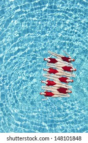 Group Of Synchronized Swim Team Performing In Pool