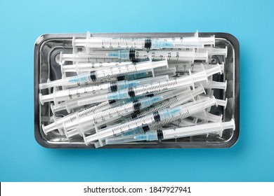 Group of syringes on a metal tray.