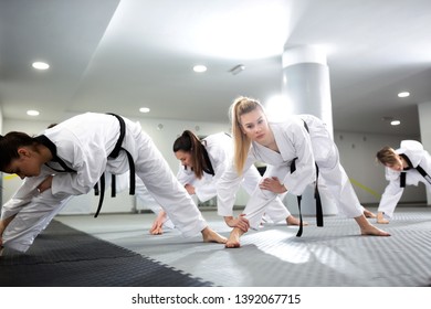 Group Of Taekwondo Athletes Stretching And Training Together With Their Physically Disabled Friend, Group Training Concept