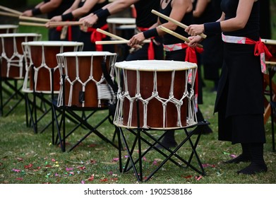 Group Of Taiko Drummers Drumming On Japanese Drums Together.