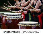 Group of Taiko drummers drumming together on Japanese Drums during a Japanese national holiday in Japan.