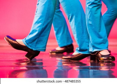 group of tap dancers feet on a shiny stage