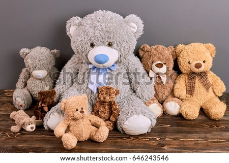 Group of teddy bears. Soft toys on brown wood. Online toy shop.