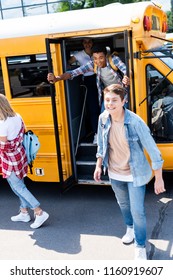 Group Of Teen Scholars Running At School From Bus