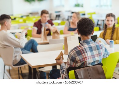 Group Of Teen Students Chatting While Taking Lunch At School Cafeteria