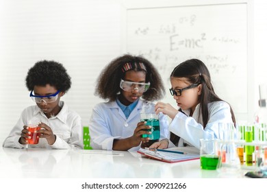 Group of teenage cute little student child learn science research and study doing a chemical science experiment making analyzing and mix liquid in test tube on class at school.Education
