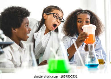 Group of teenage cute little students child learning research and doing a chemical experiment while making analyzing and mixing liquid in test tube at experiment laboratory class at school.Education - Powered by Shutterstock