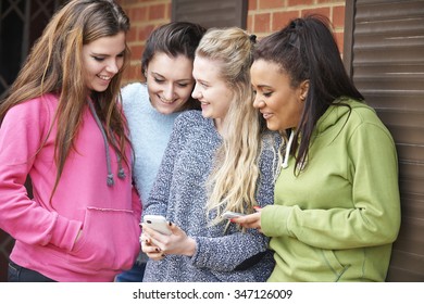 Group Of Teenage Female Friends Reading Text Message - Shutterstock ID 347126009