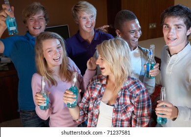 Group Of Teenage Friends Dancing And Drinking Alcohol