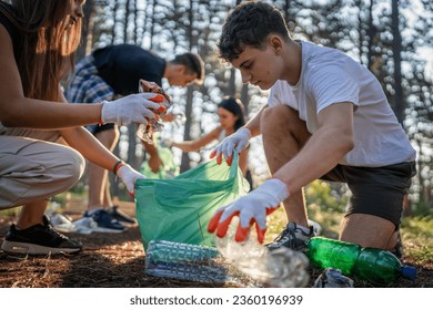 group of teenage friends gen Z male and female caucasian men women picking up waste garbage plastic bottles and paper from the forest cleaning up nature in sunny day environmental care ecology concept - Powered by Shutterstock